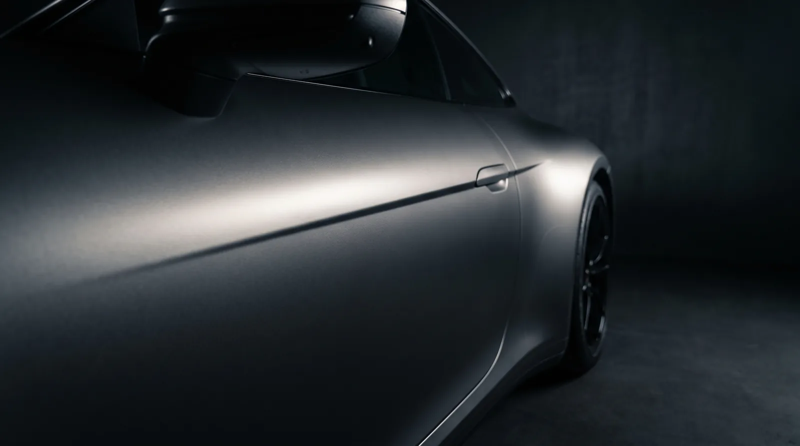 Satin gunmetal finish across a car door and quarter panel