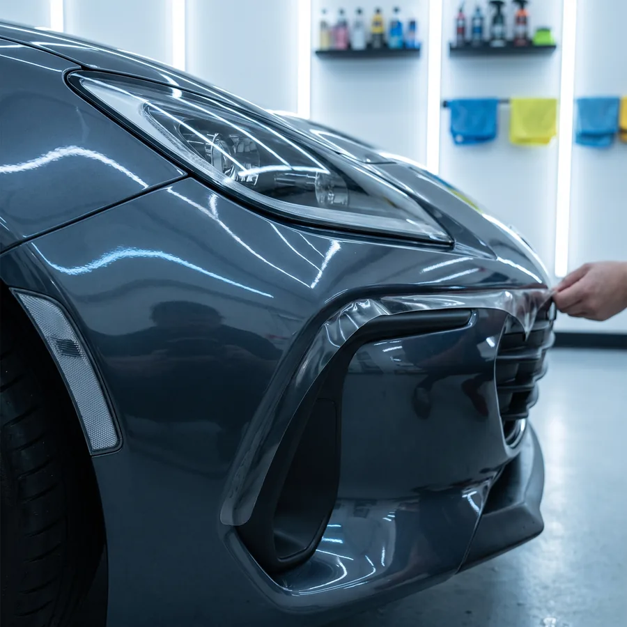 Clear paint protection film wrapped around a front bumper corner