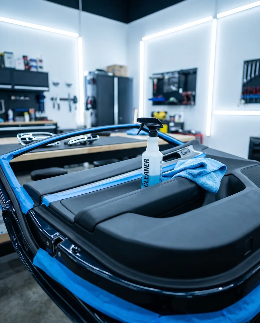 Car door prepared for wrap with the handle removed and edges masked